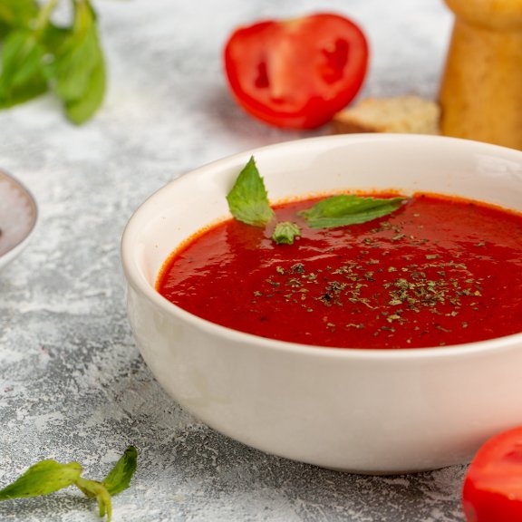 front-close-view-delicious-tomato-soup-with-greens-grey-soup-meal-dinner-vegetable